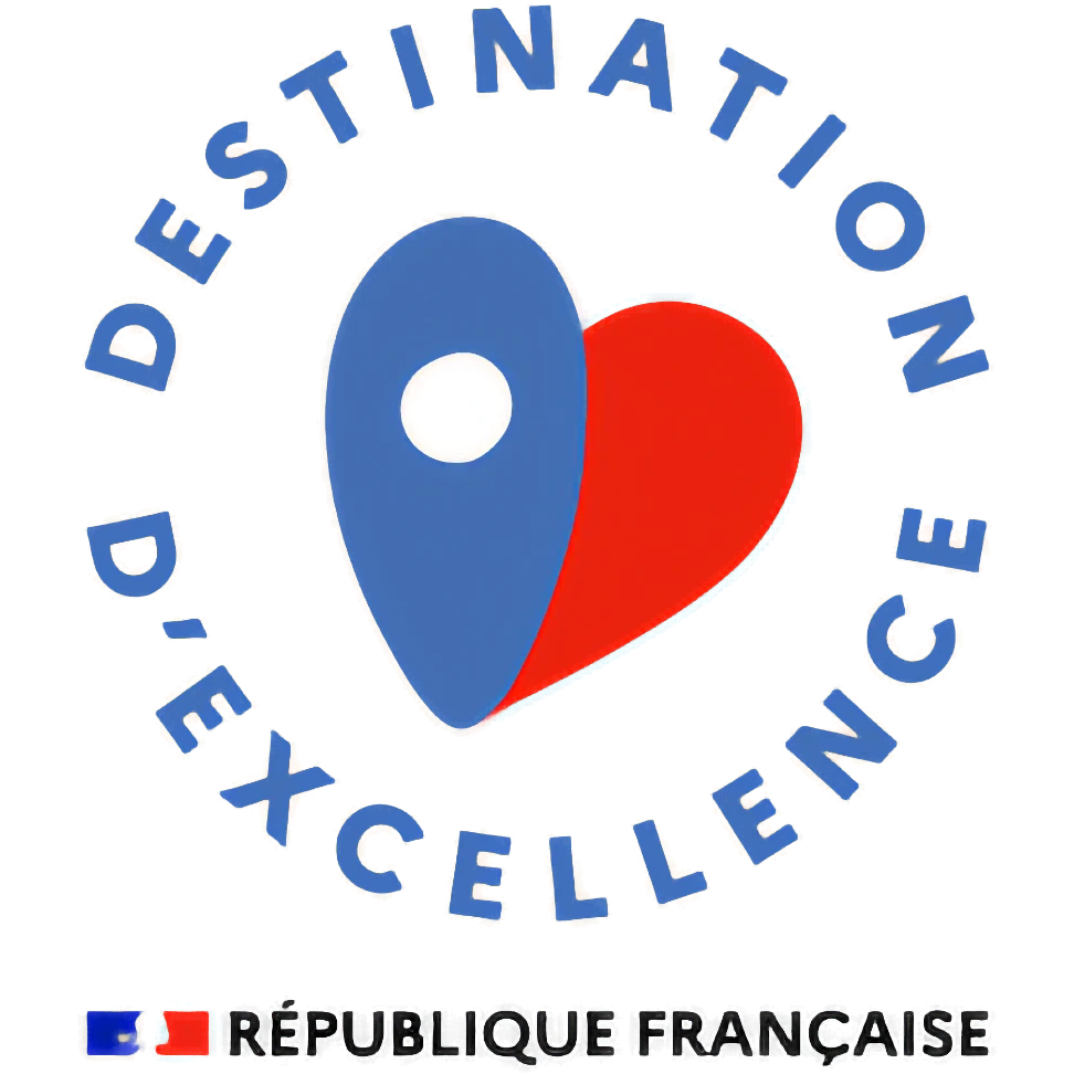 Logo “Destination of Excellence – French Republic,” a stylized blue and red heart with a location marker, representing the official tourism label in France.